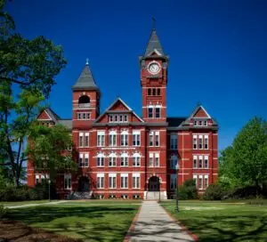 Front view of Samford Hall, Auburn University, with its iconic clock tower on a sunny day.